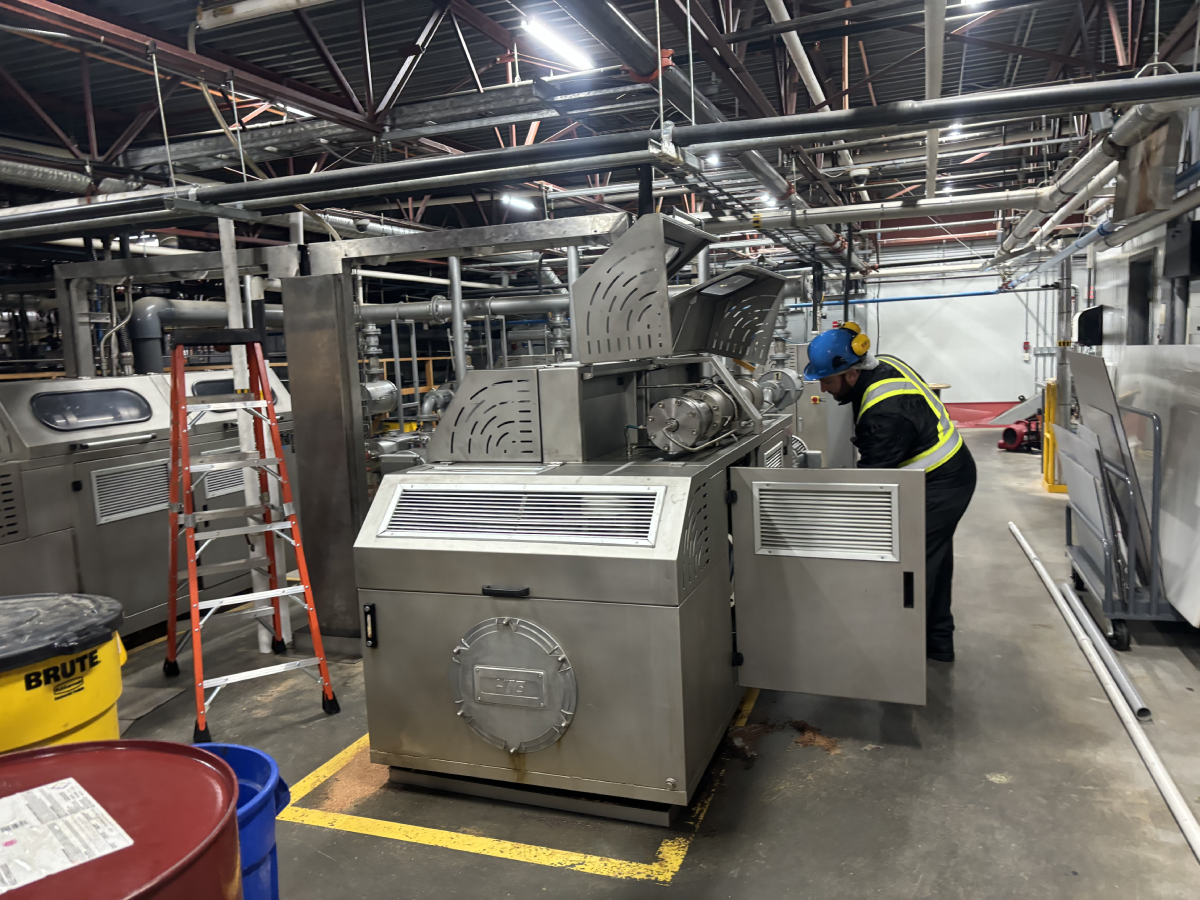 Millwright crew setting and levelling industrial equipment — equipment installation in BC facility